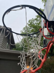Old nylon outdoor basketball net with tears