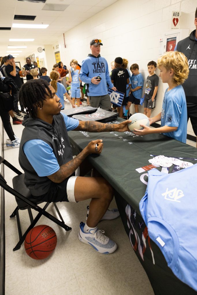 Caleb Love signing autographs at his NIL Next Gen Basketball Camp