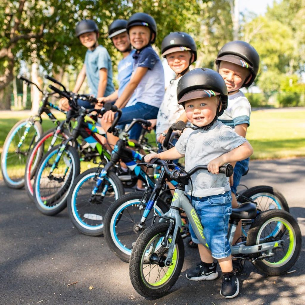 6 kids posing on Gaurdian Bikes little to big