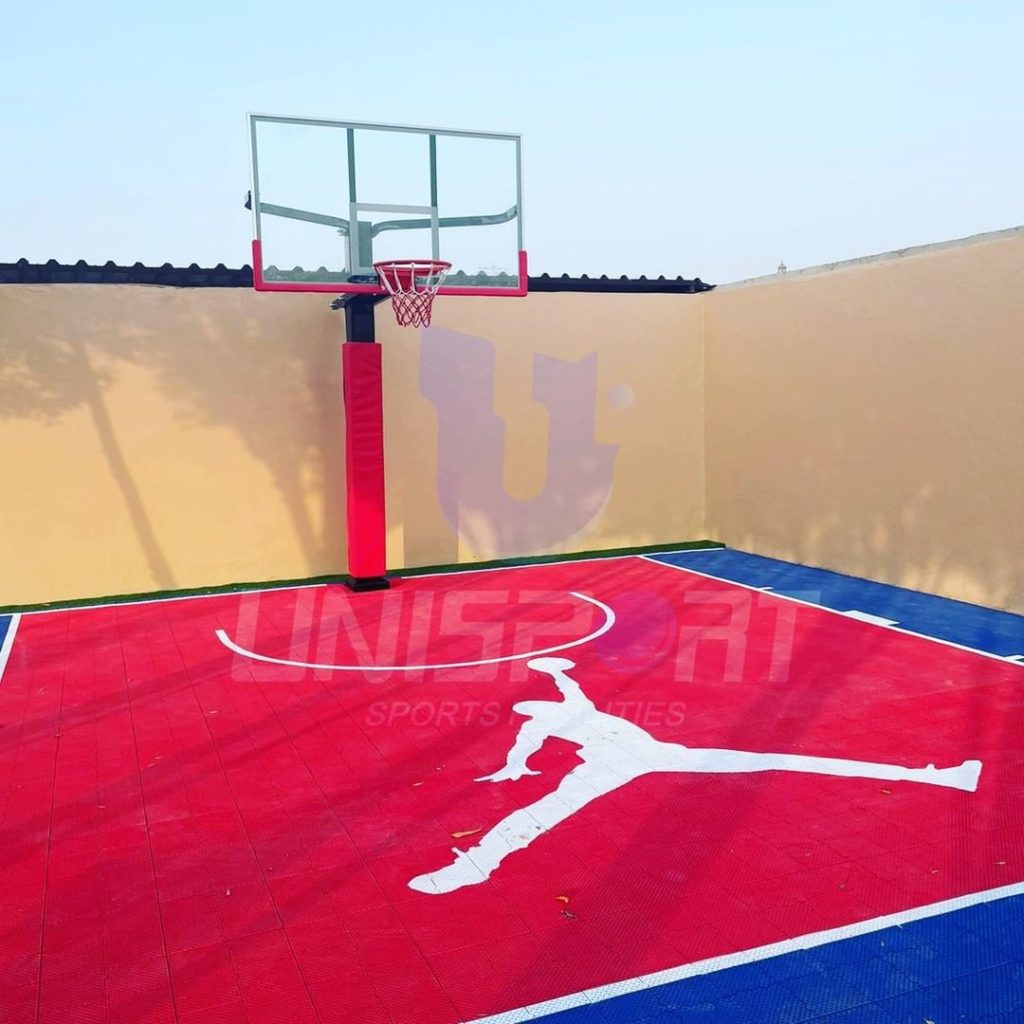 Michael Jordan logo painted on an outdoor basketball court with stencils