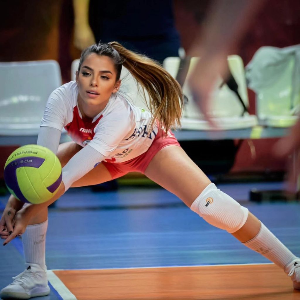 Female volleyball player digging with sleeves