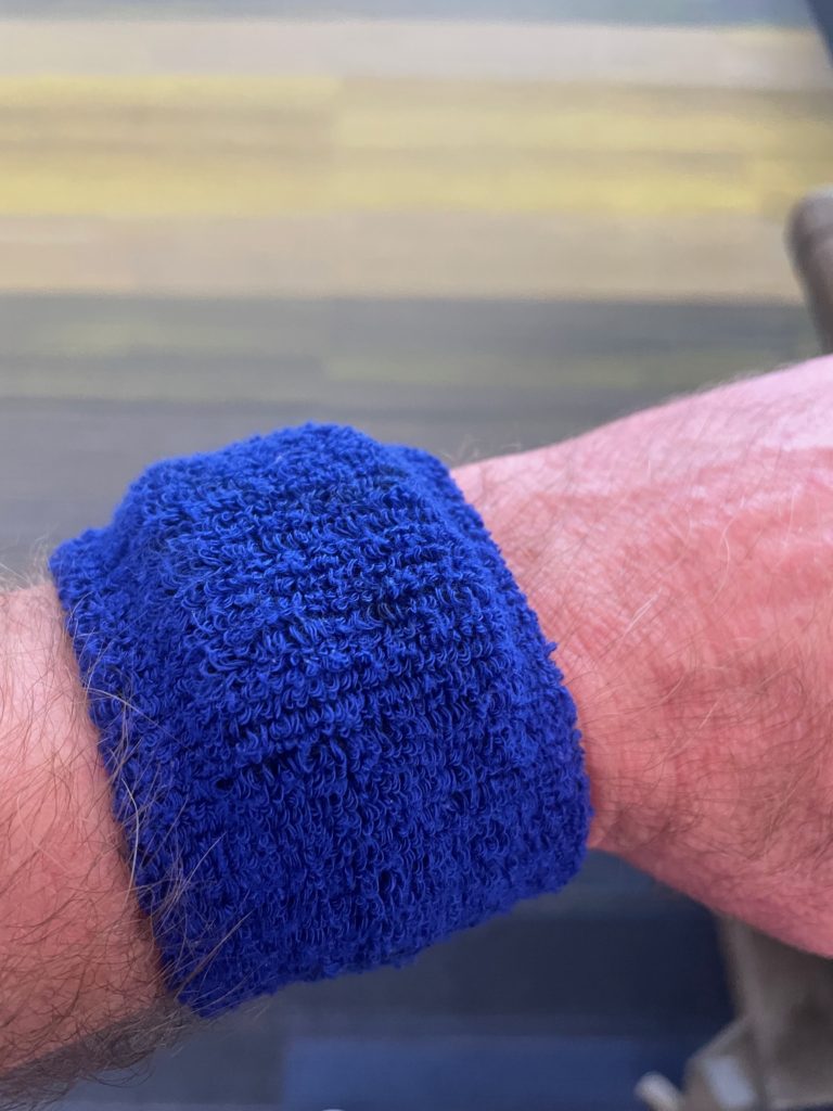 Whoop band-under a blue sweatband on my wrist